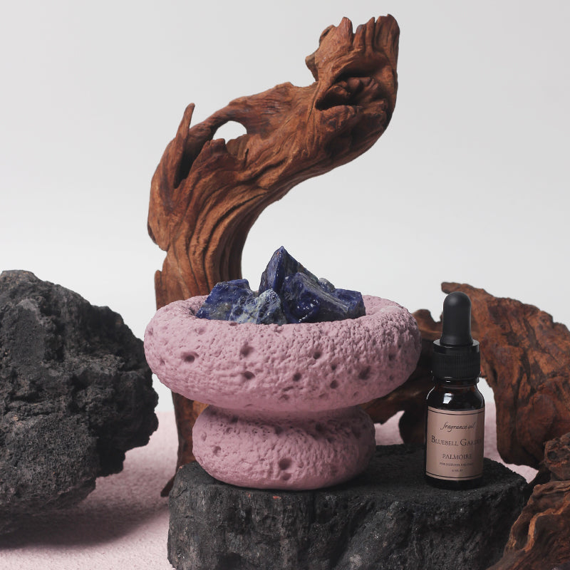 Purple Moon Vessel diffuser with blue grey crystal stones, styled with natural wood and stone elements, paired with Bluebell Garden fragrance oil