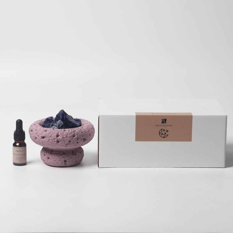 Purple Moo Vessel diffuser with Bluebell Garden fragrance oil displayed next to minimalist branded packaging box