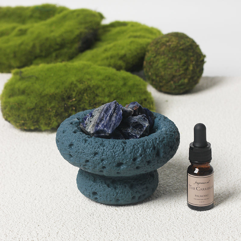 Blue Moon Vessel diffuser with crystals and Caribbean fragrance oil displayed next to minimalist branded packaging