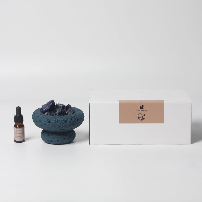 Blue Moon Vessel diffuser with crystals and Caribbean fragrance oil displayed next to minimalist branded packaging