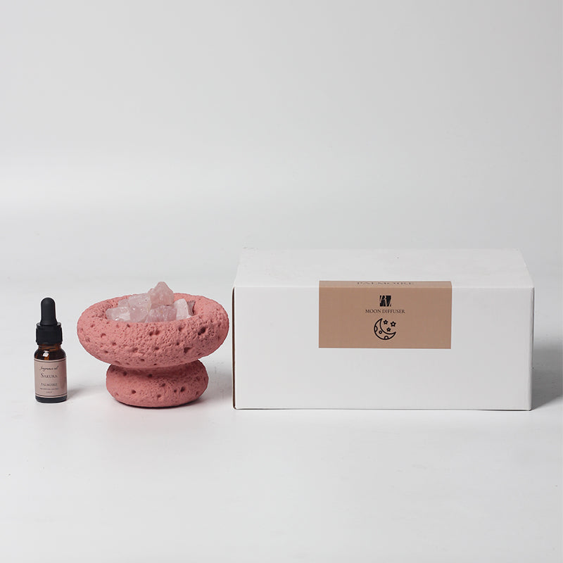 Pink Moon Vessel diffuser with Sakura fragrance oil displayed beside minimalist branded packaging box
